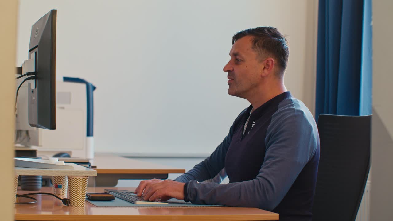 busy European Dutch Caucasian white man male adult model working in the office job on desktop workspace and feels very tired exhausted and drained with fatigue, digital film look