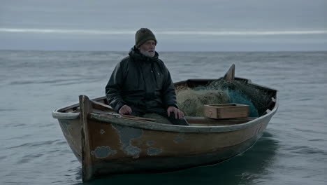 old man in a fishing boat on a gloomy day