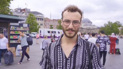 Young-man-smiling-at-camera.