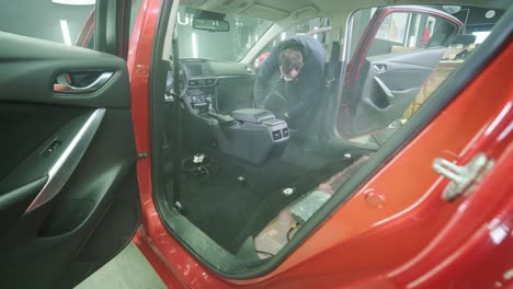 professional car cleaning. сar wash. interior detailing. dry clean and detail a car interior. deep cleaning of the car body and seats. wiping foam in car wash. cleaning the car panel from dust. a vacuum cleaner