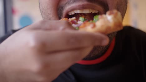 Close-up of a person eating pizza
