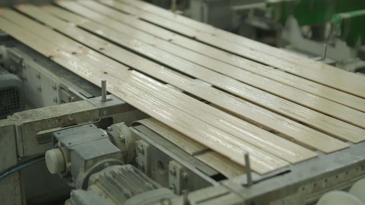 Wooden Slats Moving on a Conveyor Belt in a Factory