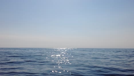 glistening blue ocean water on a sunny horizon