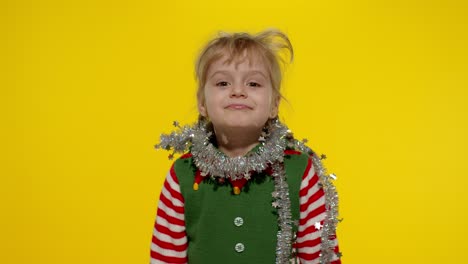 Kid-girl-in-Christmas-elf-Santa-helper-costume-dancing,-fooling-around.-New-Year-holiday-celebration