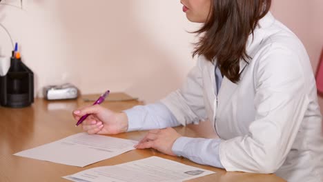 Doctor Filling Out Medical Forms