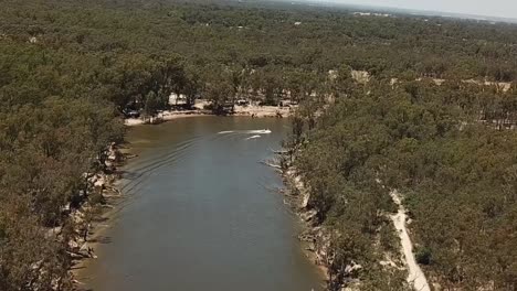 Outdoor-nature-drone-aerial-slow-pan-speed-boat-on-river