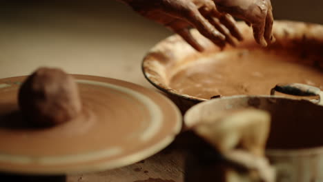 unknown woman preparing hands for sculpting in workshop. girl modeling clay