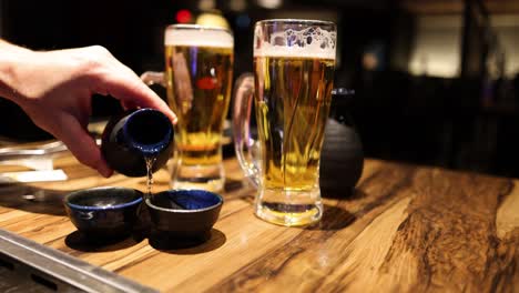 sequence of pouring a shot into a beer glass