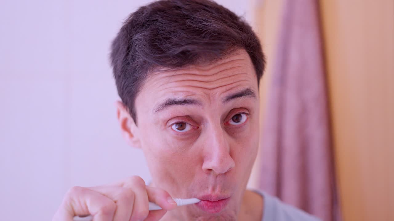 Man brushing teeth in bathroom mirror reflection montage