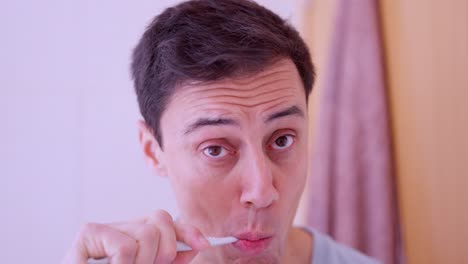 man brushing teeth in bathroom mirror reflection montage