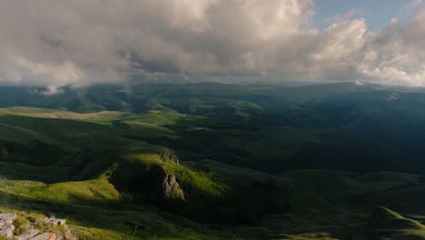 Low-clouds-over-a-highland-plateau-in-the-rays-of-sunset.-Sunset-on-Bermamyt-plateau-North-Caucasus,-Karachay-Cherkessia,-Russia.