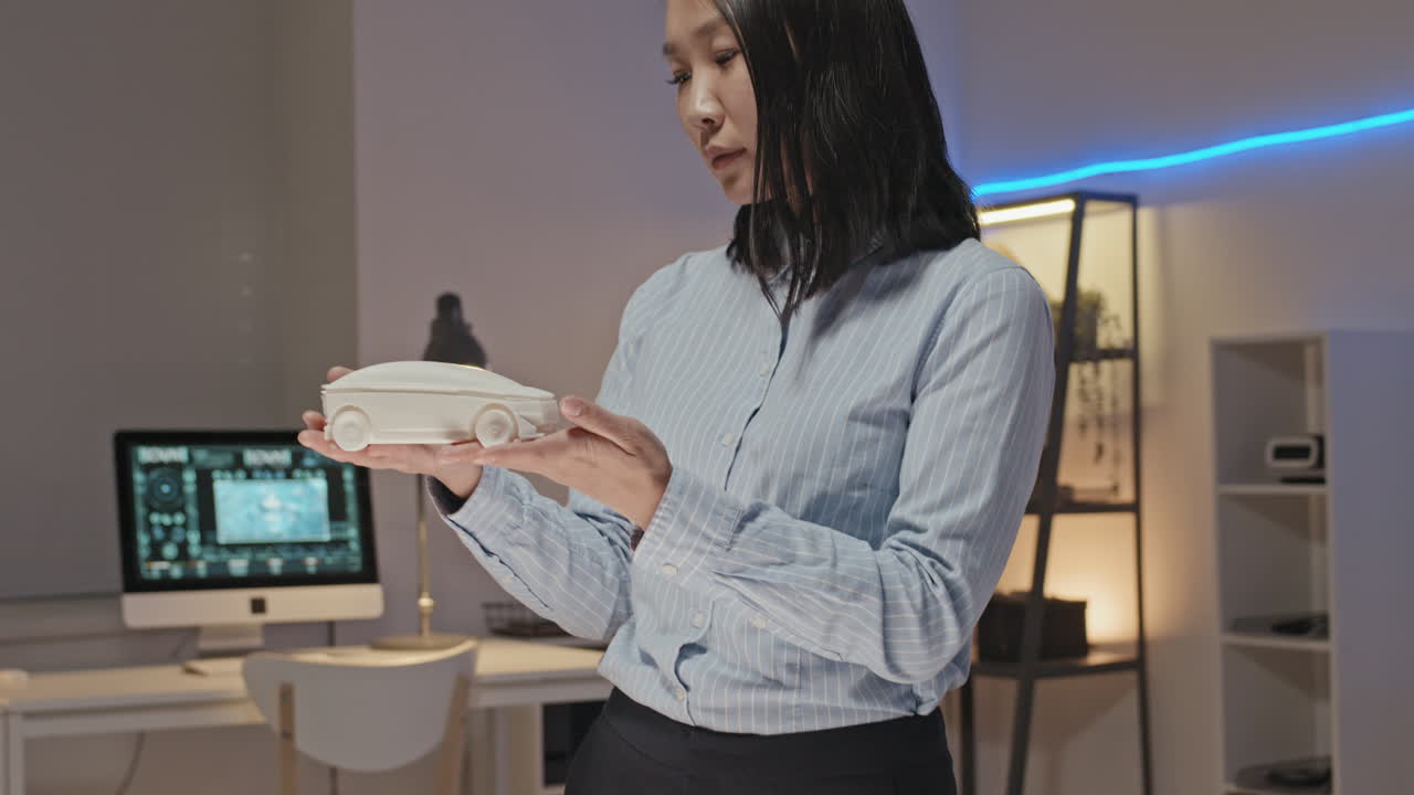 Slowmo of Female Engineer Inspecting 3D Printed Prototype
