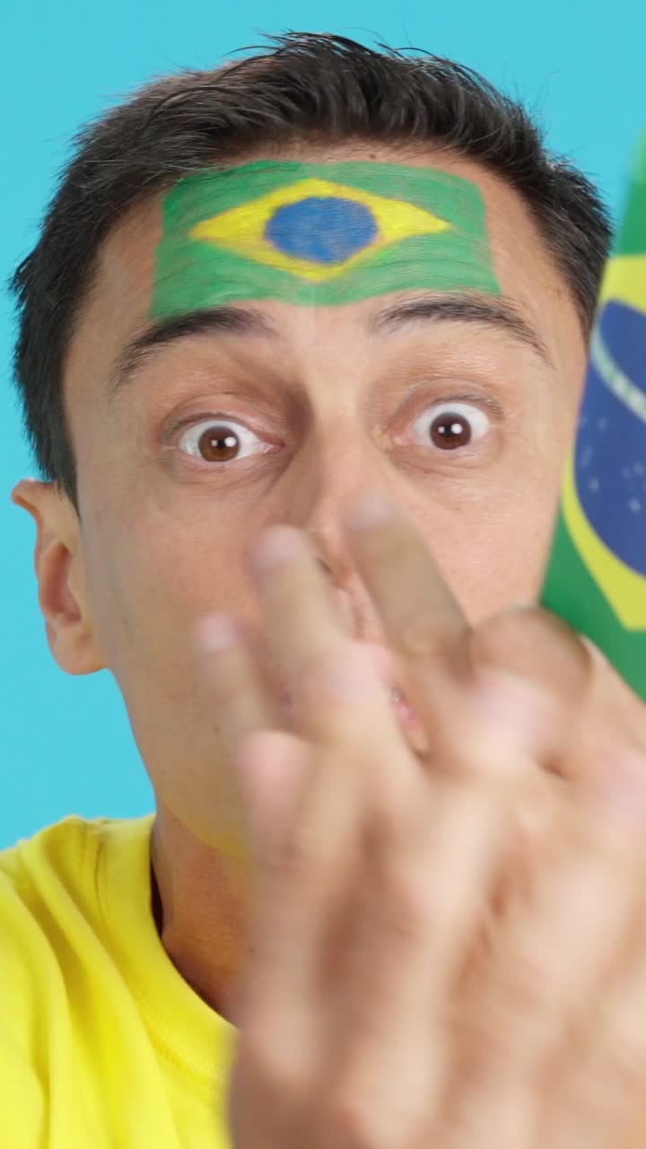 Man with brazilian national flag upset with a football referee