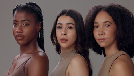 three diverse women smiling for a portrait