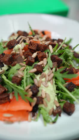 vertical footage fresh salmon salad is garnished with croutons, arugula, and a creamy avocado dressing, creating a vibrant and healthy culinary experience