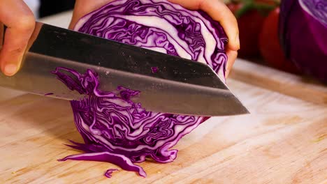 slicing cabbage on a wooden cutting board