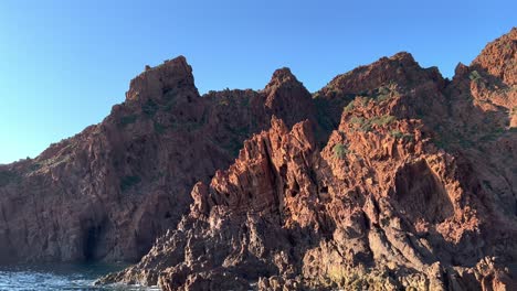 primordial scandola peninsula nature reserve in summer season as seen from moving boat, corsica island in france