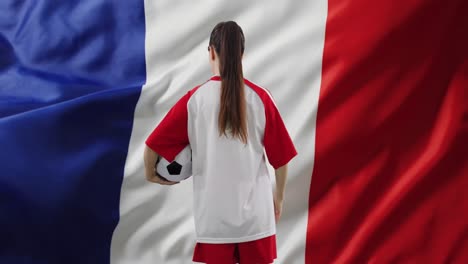 animation of caucasian female soccer player over flag of france