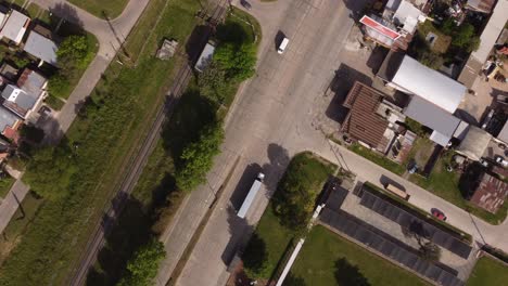 Aerial-top-down-shot-of-industrial-truck-departing-factory-for-distrubution-of-goods-during-sunlight---Buenos-Aires,Capital-of-Argentina