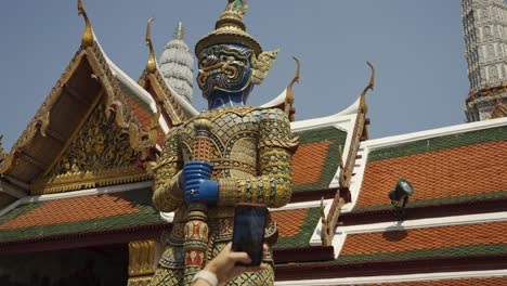 slow motion shot of a female tourist admiring the temple of the emerald buddha