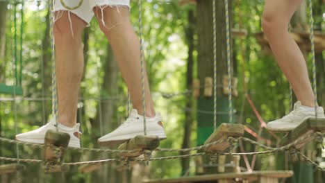 adventure climbing high wire park - people on course in mountain helmet and safety equipment