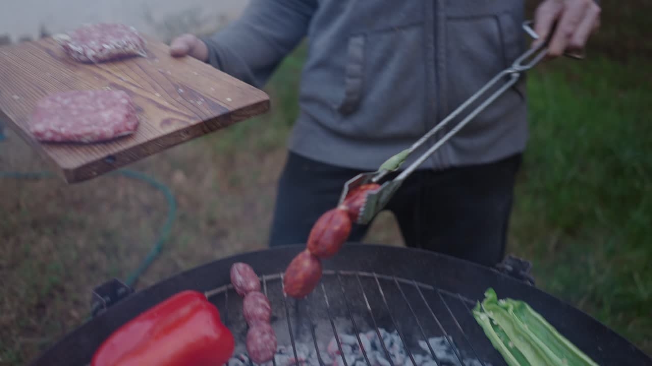 Grilling Outdoors with Sausage, Burgers, and Vegetables