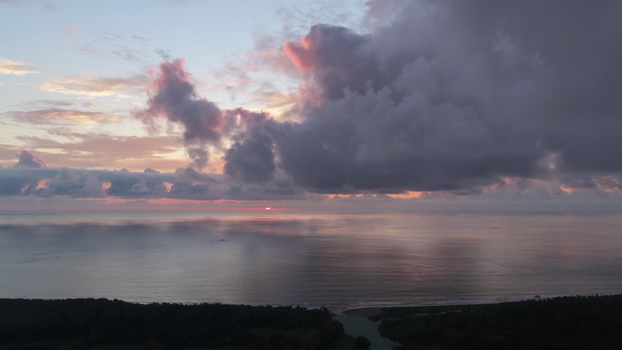 Aerial View of Dramatic Sunset Over Tropical Ocean and Coastline