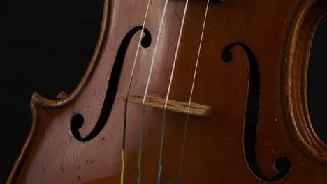 Closeup-acoustic-violin-musical-instrument-bridge-and-F-holes,-rotate