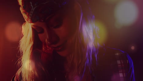 mid-adult woman performing on club stage, showing animated light flares and bokeh for ads