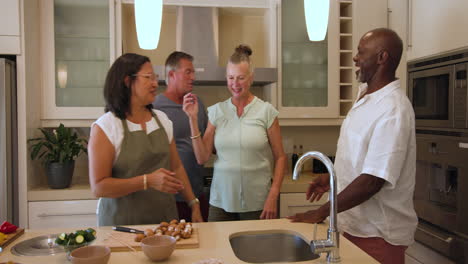 preparing meal together, diverse friends sharing laughter and conversation in kitchen, at home