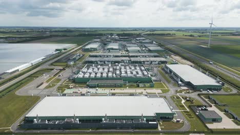 expansive drone shot showing the full scale of a data center complex at eemshaven, used for cloud platforms, big data processing, and ai infrastructure