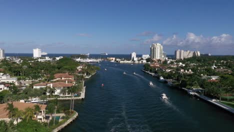 waterfront neighborhood in fort lauderdale with pleasure boats sailing in the new river in broward, florida, usa