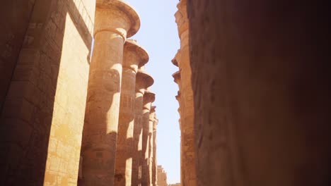 large stone pillars in the hypostyle hall, luxor egypt