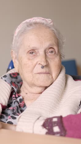senior woman looking at camera sitting in wheelchair a geriatric