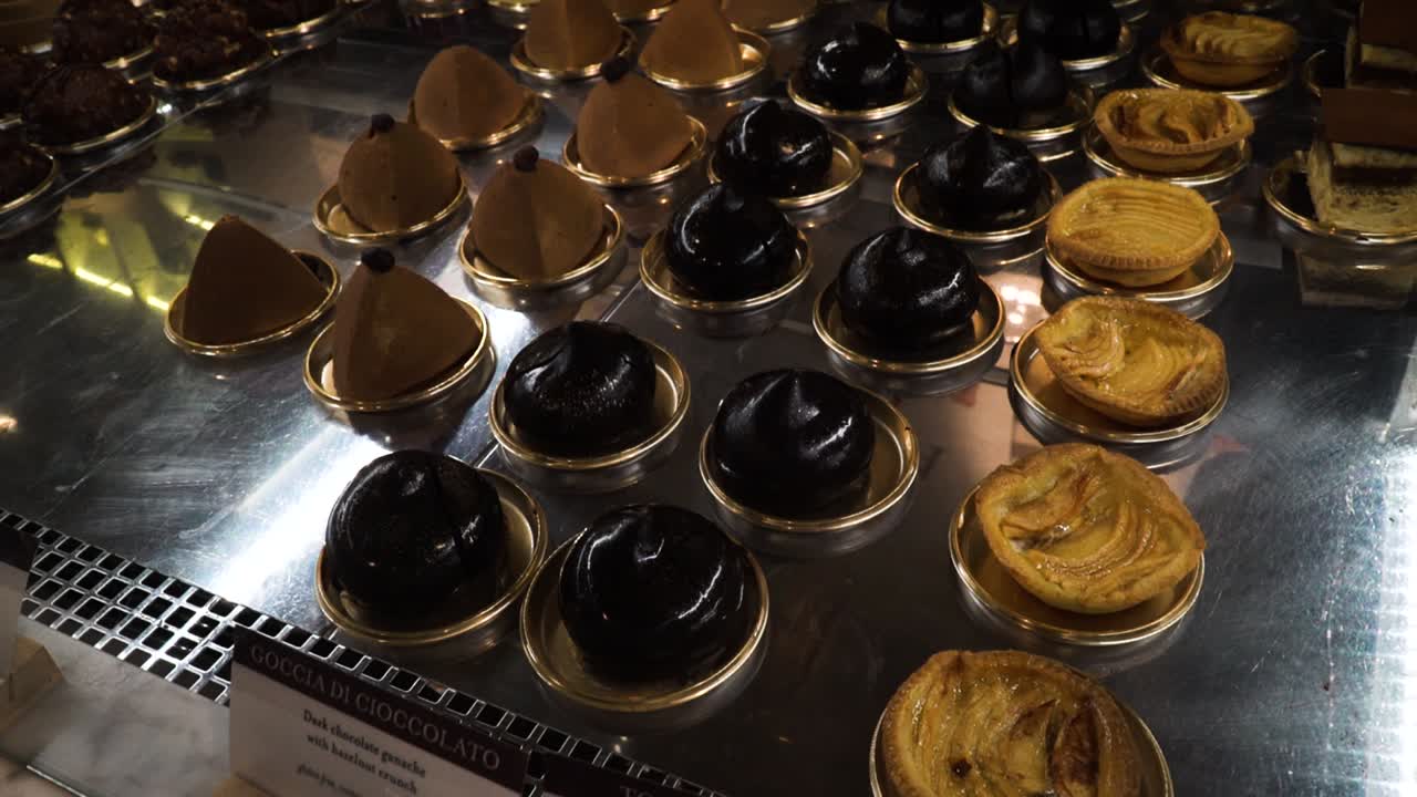 Italian desserts and french sweet chocolate pastries and cakes in the bakery window display