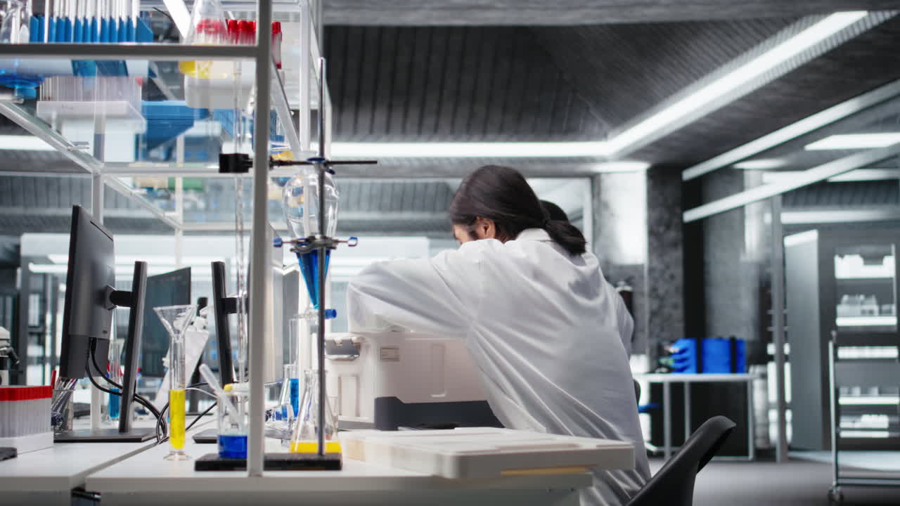 Vertical video Lab manager bringing researcher storage box containing laboratory vials