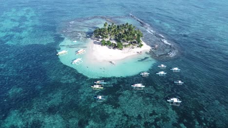 Aerial,-Tour-Boats-anchored-at-the-reef-of-Guyam-Island-in-Siargao---Philippines