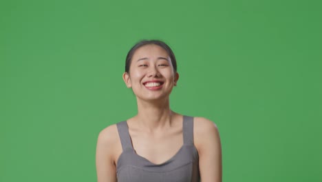 smiling woman in gray sports bra