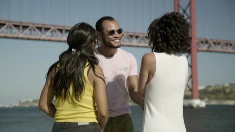 happy friends talking near river