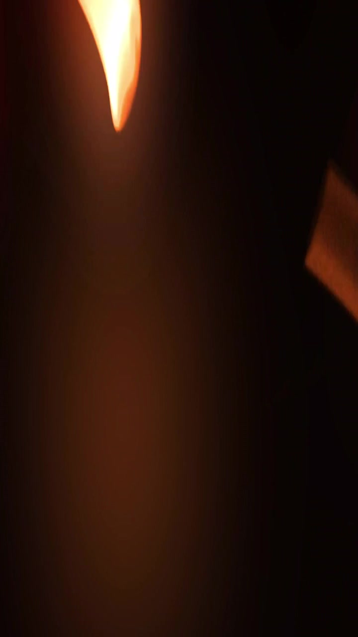 Glowing Fire Sparks Rising Against Dark Background