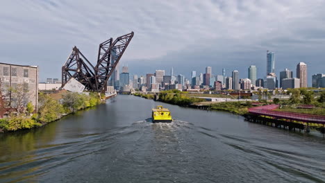 aerial view following a watertaxi on the south branch of the chicago river, fall day in usa