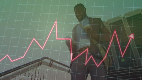 business man holding smartphone on office staircase, showing grid overlay, rising red stock chart