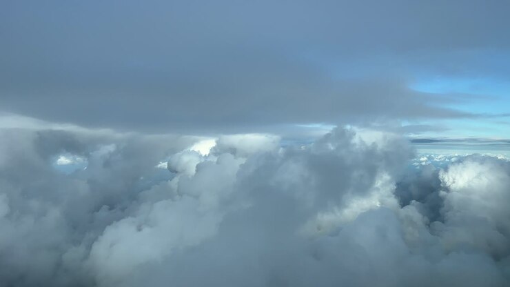 Pilot point of view from a jet cockpit while flying through a turbulent winter sky