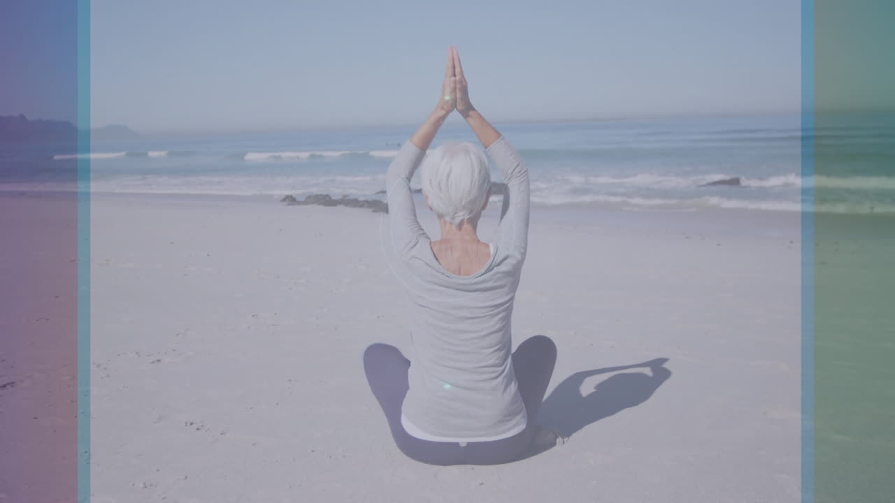 Elderly person practicing yoga on beach with digital circular animation overlay