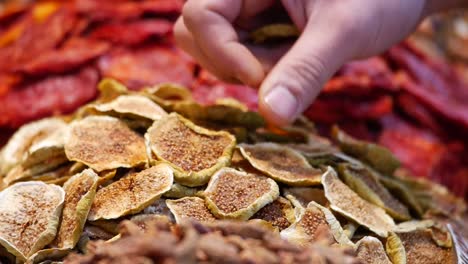 hand picking dried figs at a market