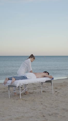 relaxing outdoor massage and cupping therapy on the beach