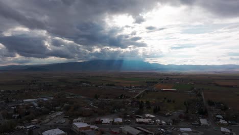 Wide-angle-drone-shot-panning-to-the-right-of-rural-farms-after-a-storm