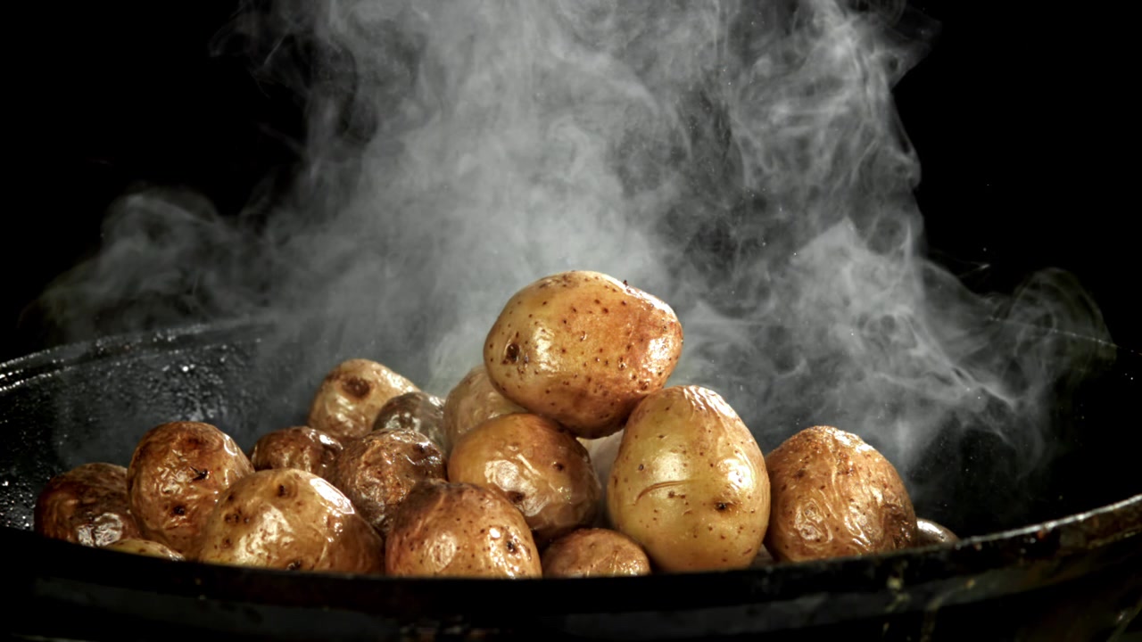 Delicious Hot Potatoes Steaming in a Black Pan