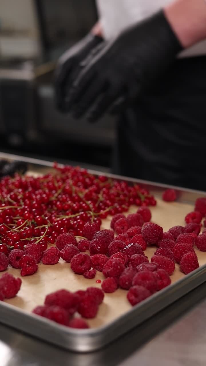 Chef preparing raspberries and red currants