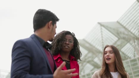 young people walking along street, talking, sharing emotions